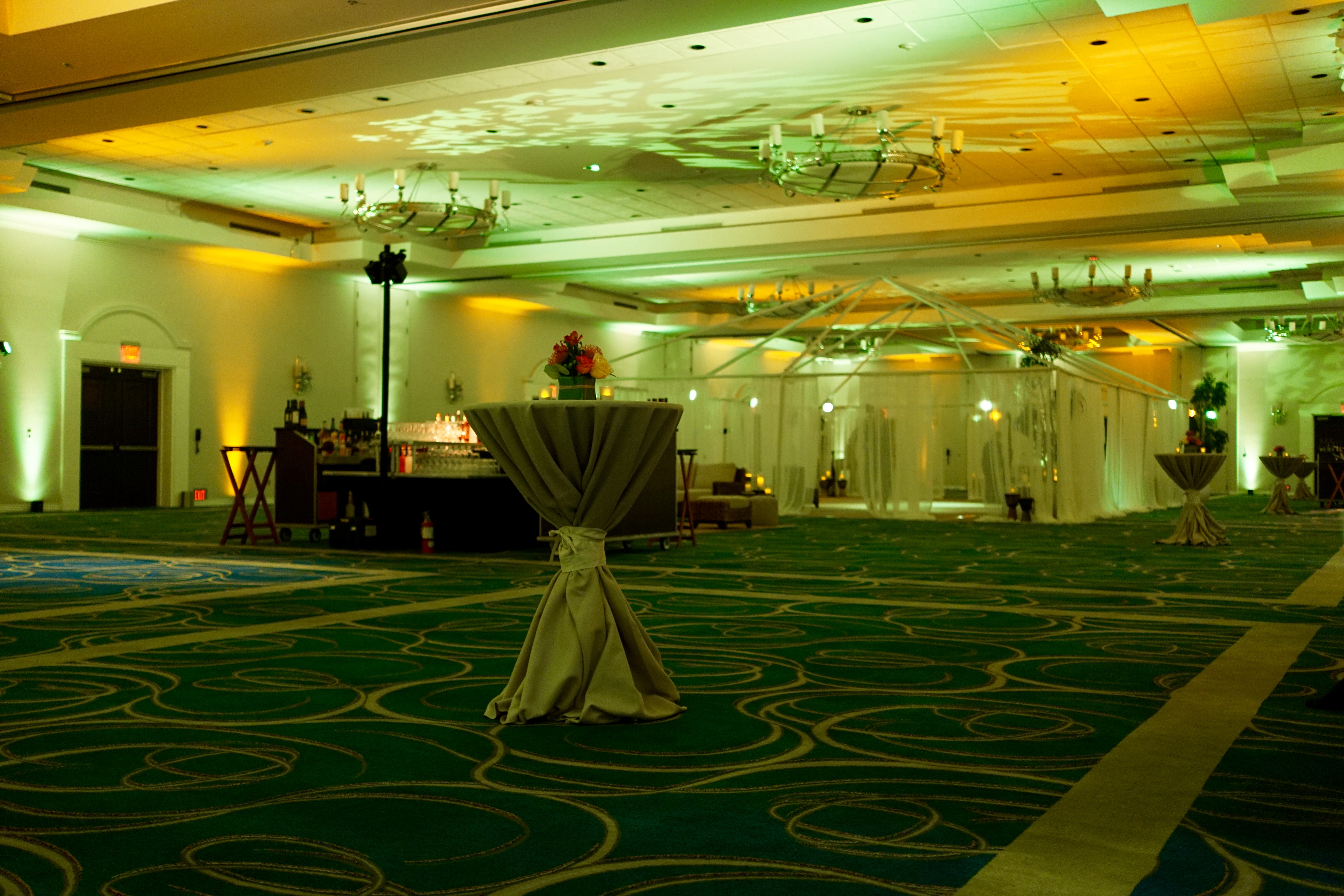 A room with green carpet and a table