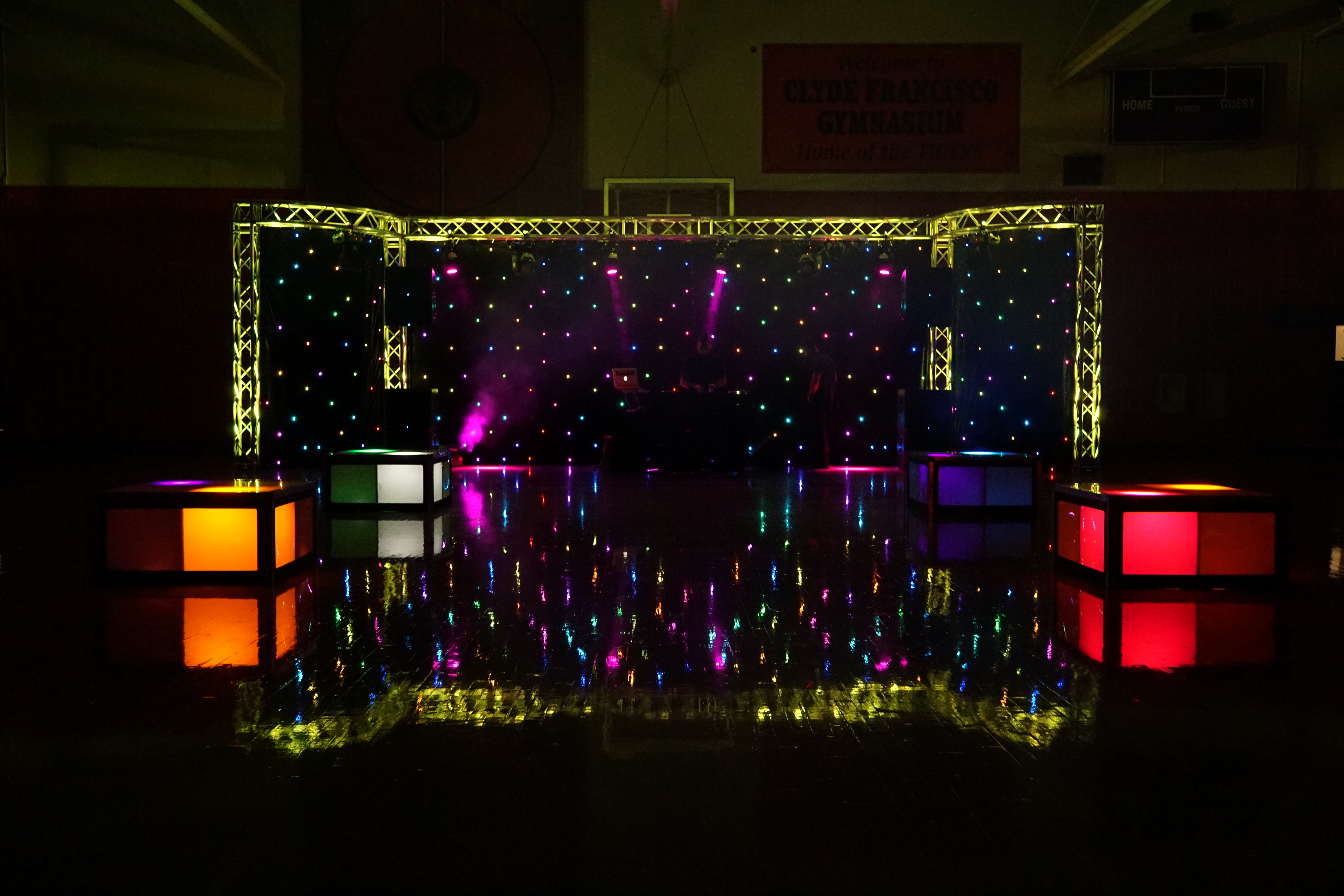 a dance stage with colorful lights at night