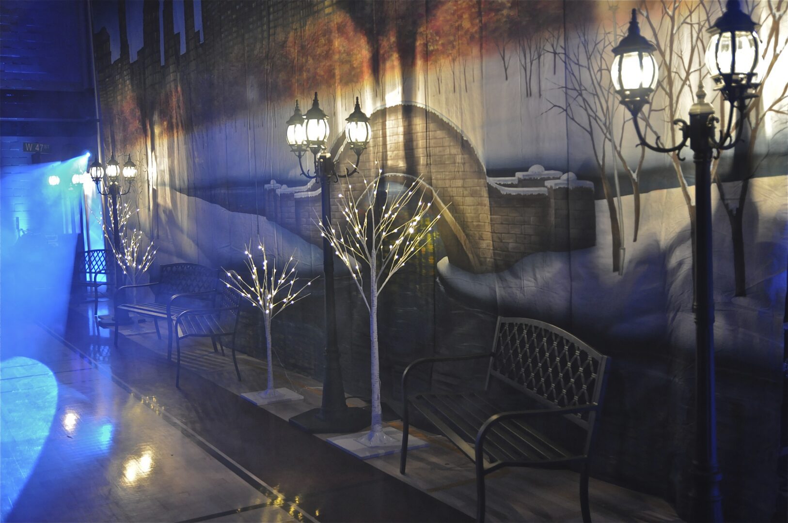 A room with lights and trees on the wall