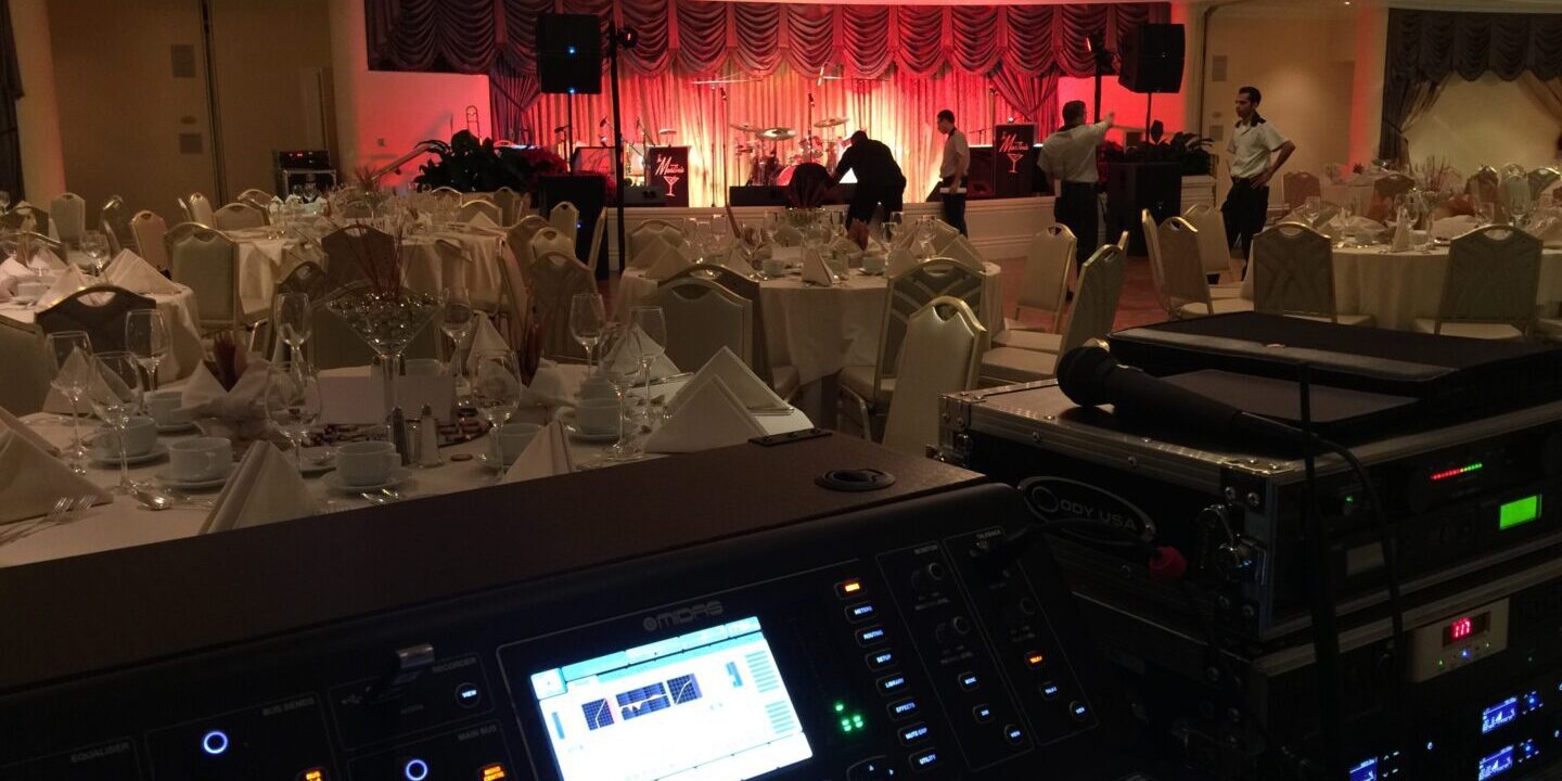 A large room with a bunch of lights and a big screen