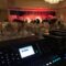 A large room with a bunch of lights and a big screen