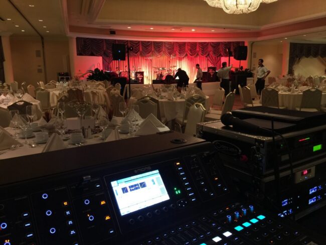 A large room with a bunch of lights and a big screen