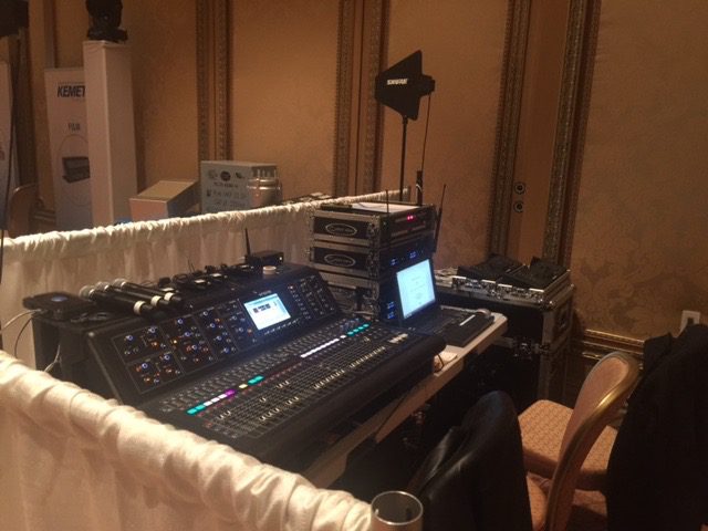 A large sound board sitting in front of a wall.