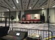 A large room with an american flag on the wall.