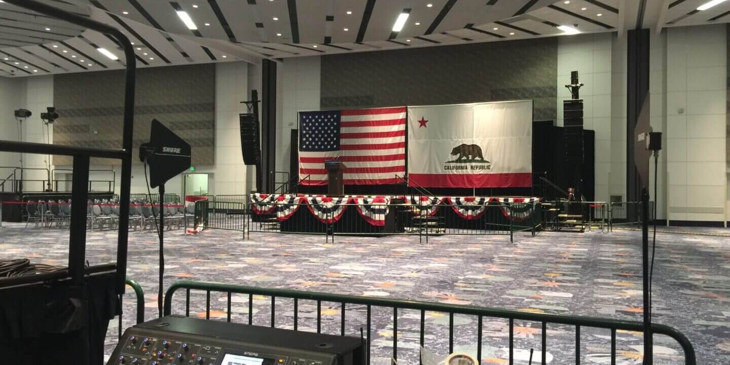 A large room with an american flag on the wall.