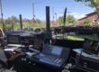 Outdoor stage setup with audio equipment and computers.